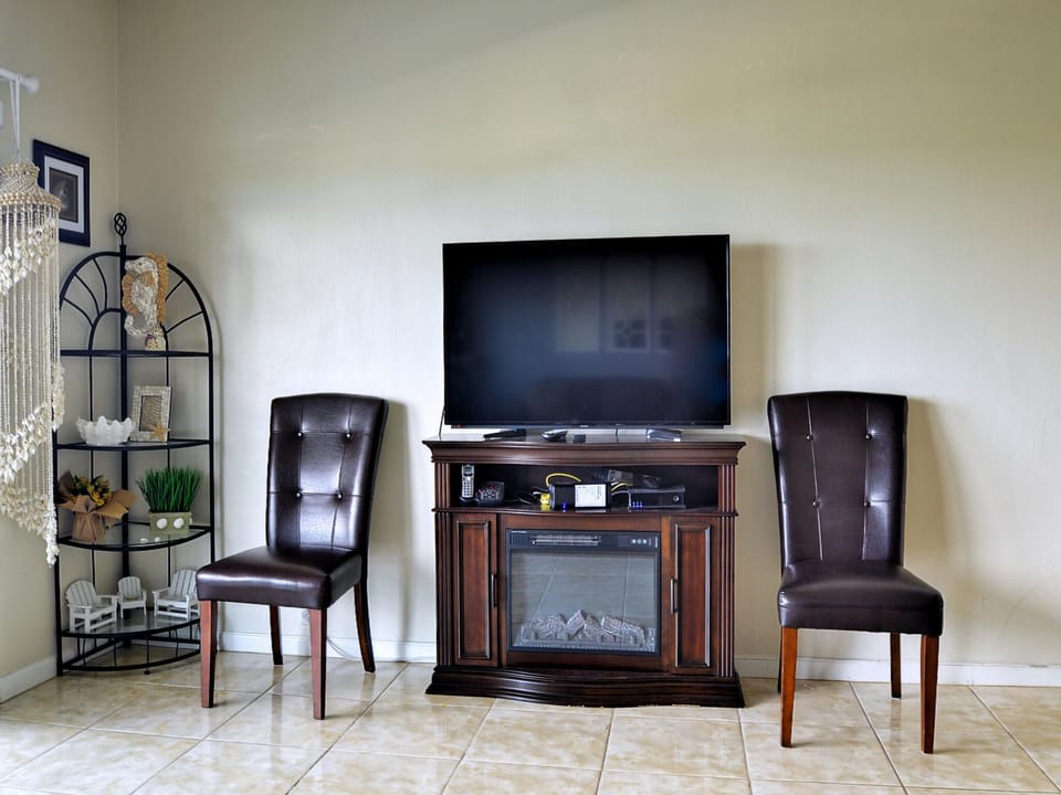Flat screen TV and electric fireplace.