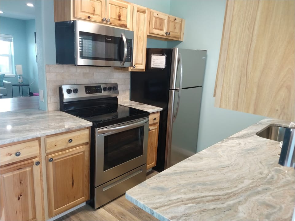 Stove, Refrigerator, and Microwave in the kitchen.