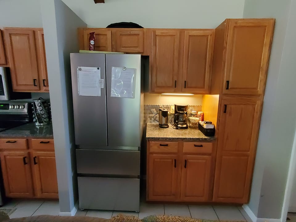 Regular coffee pot and K-cup pot.  
New stainless steel refrigerator