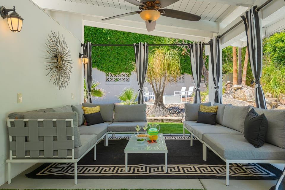 Hangout cabana with privacy curtains, loads of seating and shelter from the sun