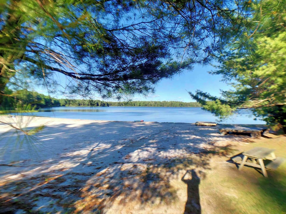 Charming lake beach is steps from our home.