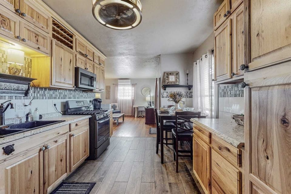 Kitchen with full gas stove/oven, refrigerator, microwave, and plenty of cabinet space for storage.