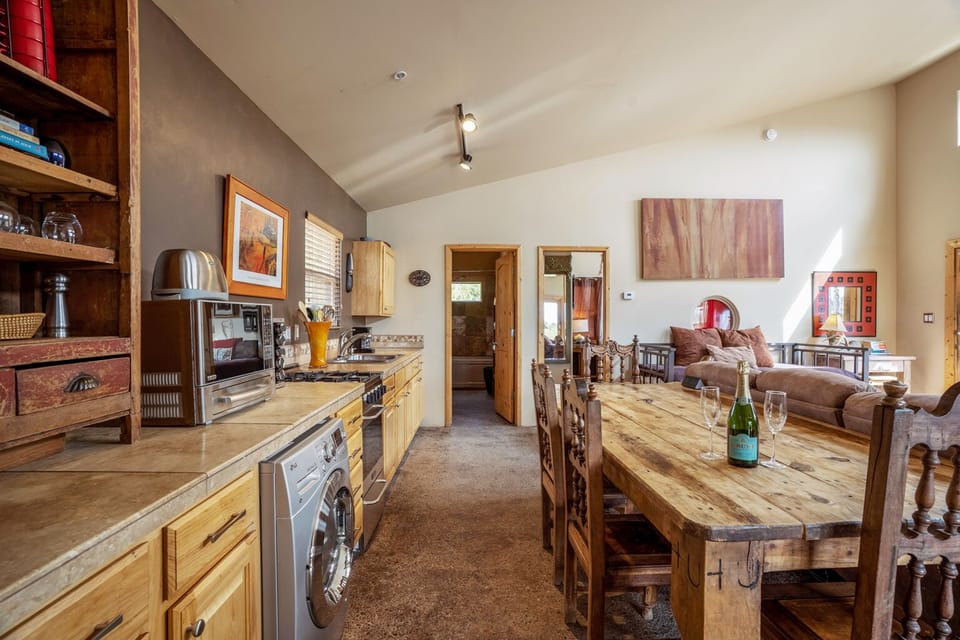 Dining area for up to 4 people, modern kitchen with stainless amenities. 
