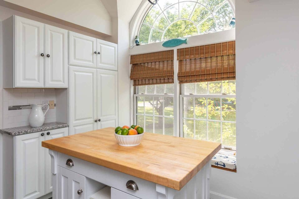 The Gourmet Kitchen Is Framed By A Large Arched Window