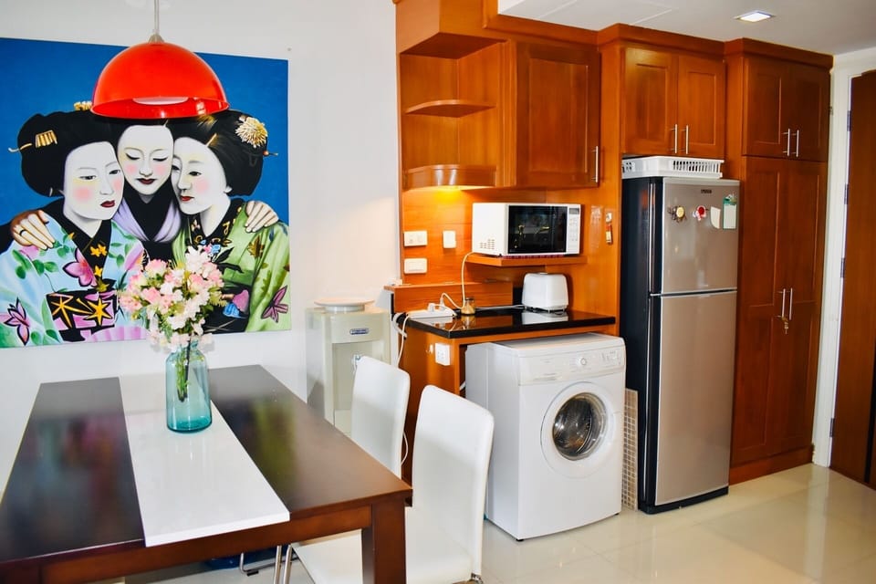 Dinning area with washing machine and good sized fridge, cold water machine