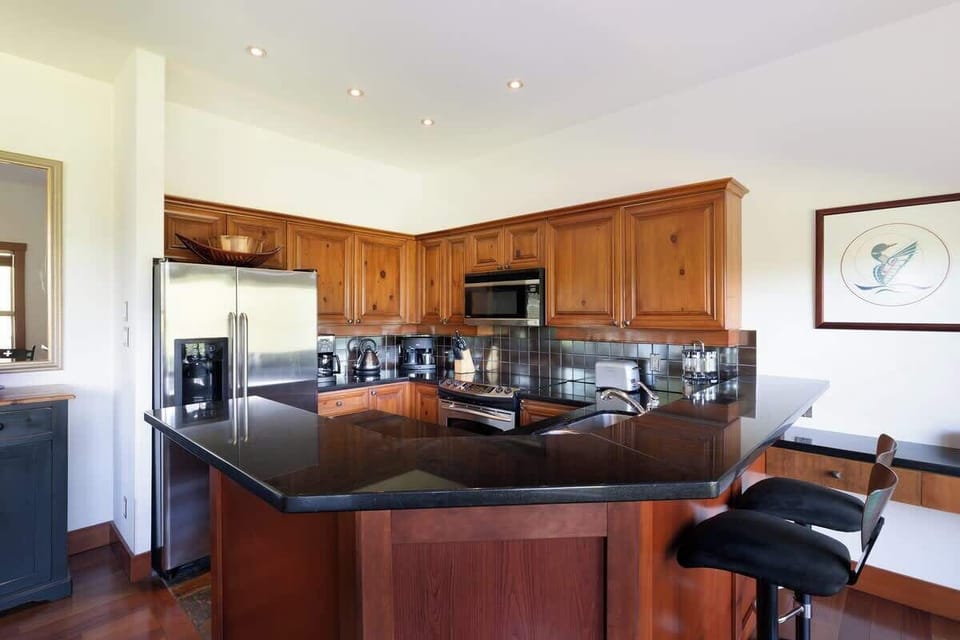 - Modern kitchen with polished granite counters and bar seating  
- Equipped with stainless steel appliances and all essentials  
- Designed for comfort and convenience during your Whistler stay  