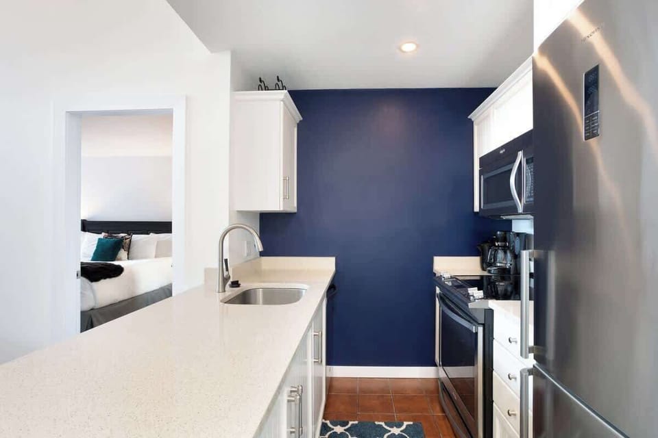 - Contemporary kitchen featuring stainless appliances and crisp white cabinetry  
- Deep blue wall adds a bold, modern touch to the cozy space  
- Fully stocked for cooking, coffee, and après-ski snacks  
