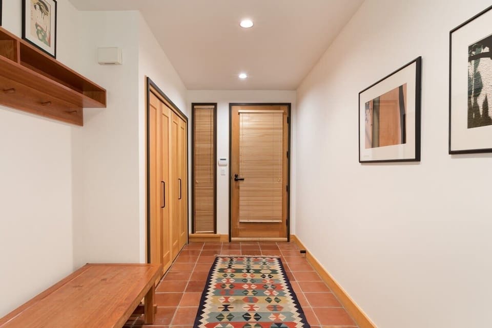 - Inviting entryway with patterned rug and built-in wood storage  
- Practical layout for boots, coats, and ski gear organization  
- A warm welcome that sets the tone for your mountain stay  

