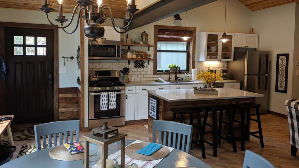 Great room that includes modern, fully functioning kitchen with island.