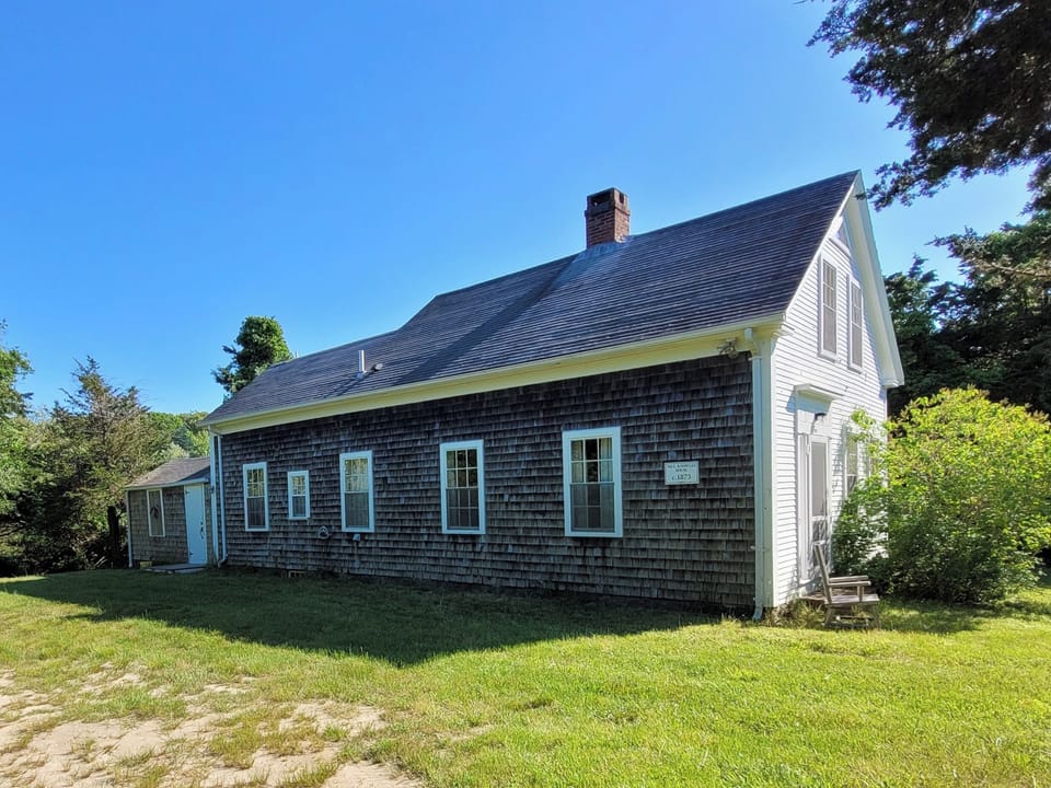 East side of the home, including historic plaque.