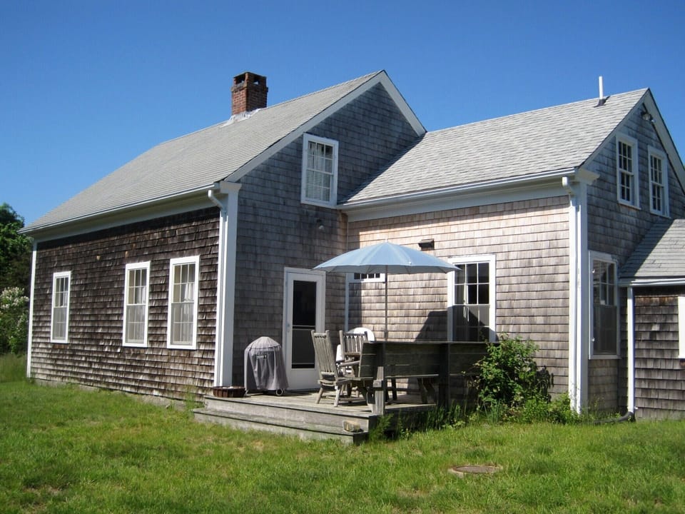 West side of house with deck.