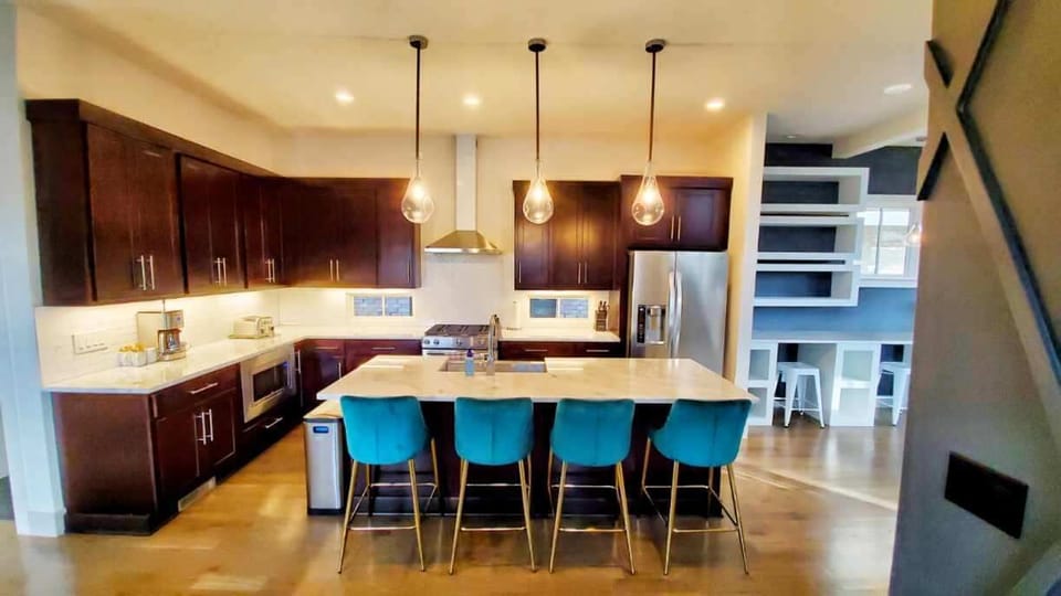 Spacious kitchen area with giant quartzite island, top shelf appliances and all 