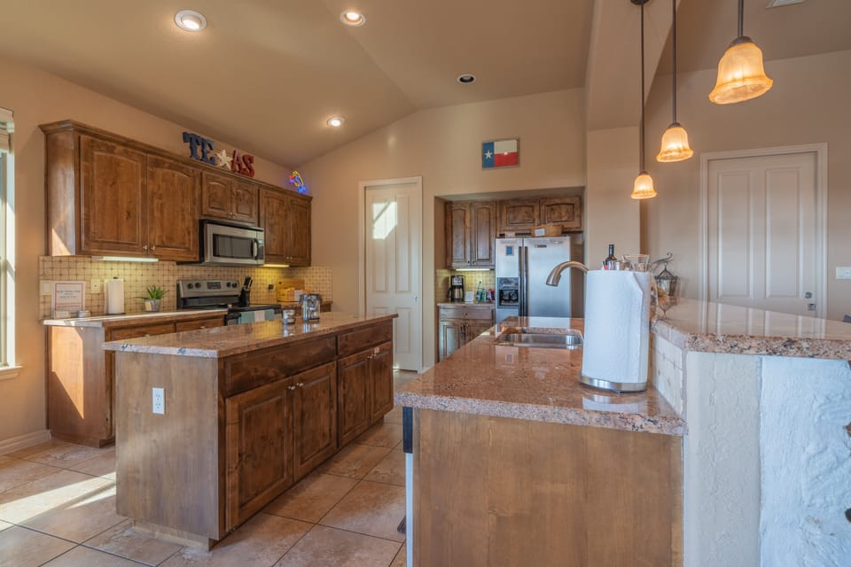 Large kitchen with center island.  Granite counter tops & real wood cabinets.