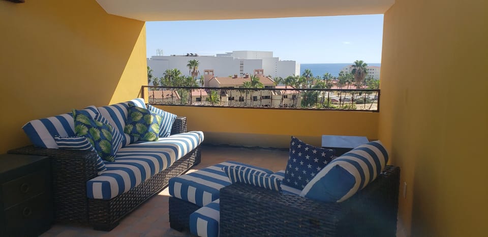 Rooftop lounge area Tommy Bahama overstuffed woven bamboo furniture 