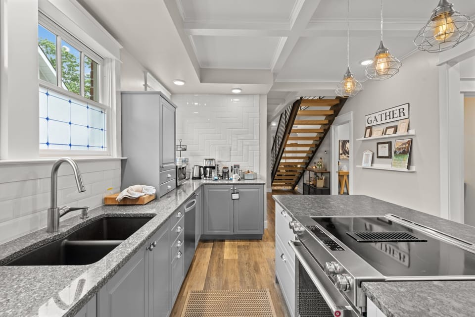 Kitchen— generous granite countertops & wide aisles accommodate communal cooking