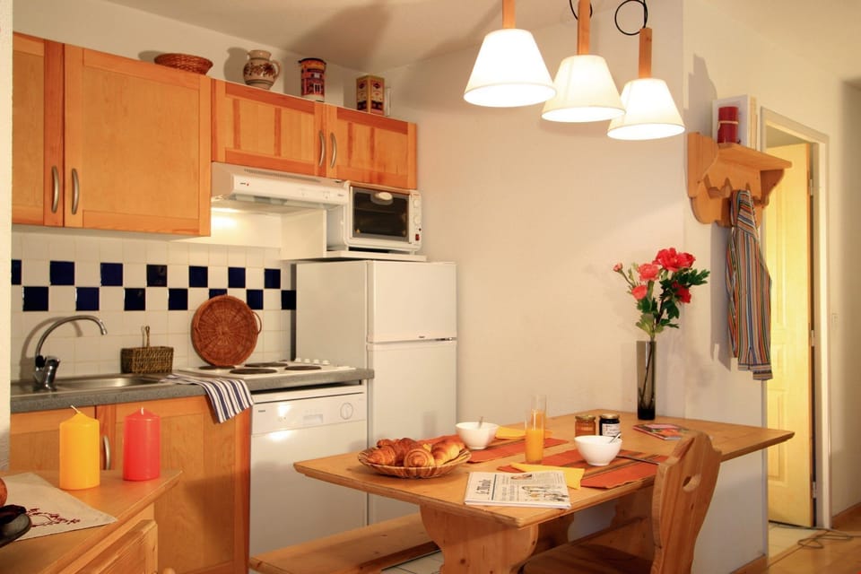 Prepare meals in the kitchenette and enjoy them at the dining table.