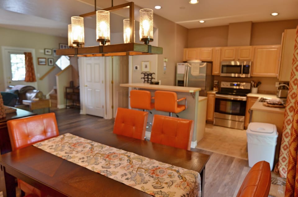 Dining Area and Fully-Equipped Kitchen - The dining room table is large enough for the entire party. The floor opens up to the fully-equipped kitchen and a large back patio.