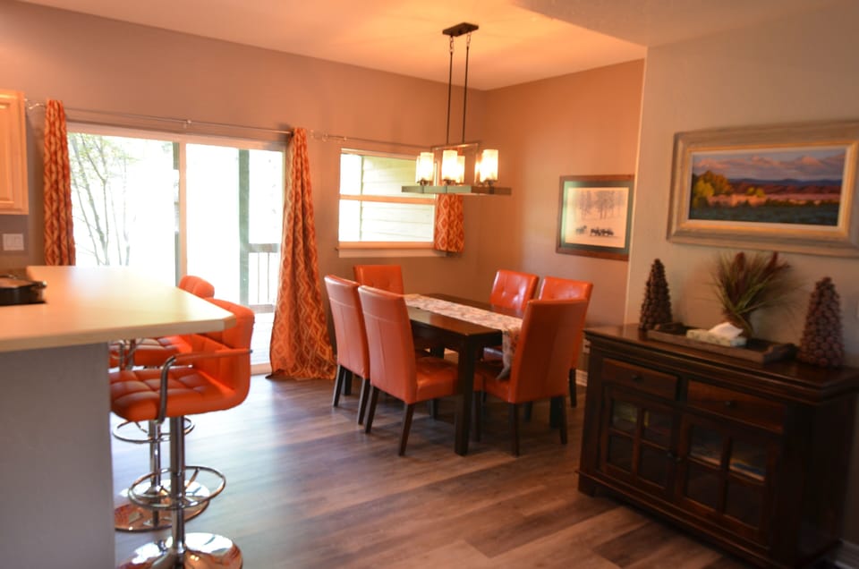 Dining Area and Fully-Equipped Kitchen - The dining room table is large enough for the entire party. The floor opens up to the fully-equipped kitchen and a large back patio.