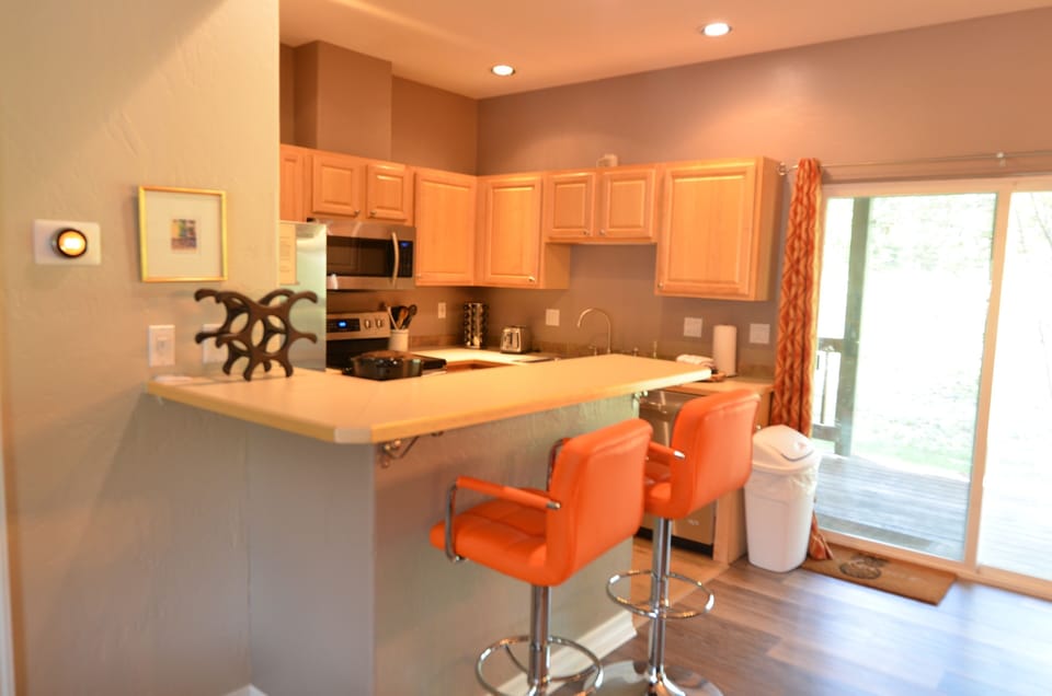 Fully-Equipped Kitchen - The kitchen is fully equipped with new appliances, a breakfast bar for extra seating, and open space into the dining area.