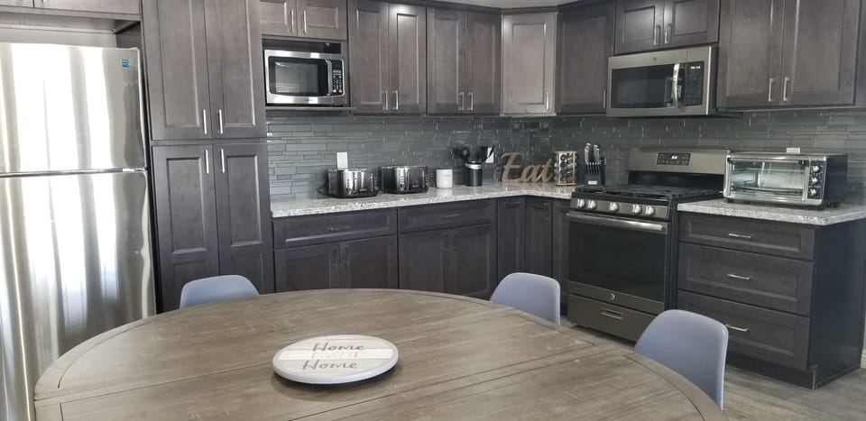 New granite kitchen countertops and cabinets. Stainless steel refrigerator