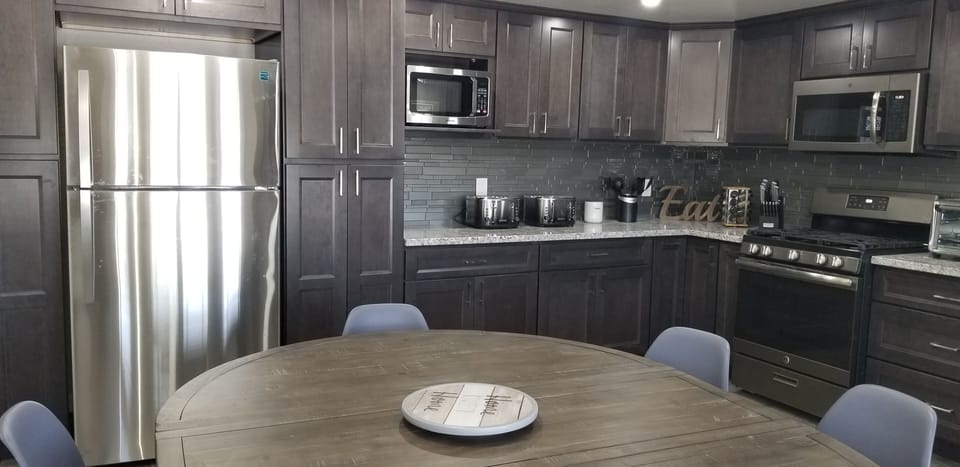 stainless steel refrigerator with top freezer and ice maker. 2 microwaves