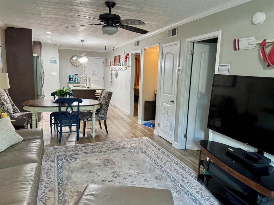 Living area with large flat screen TV. 