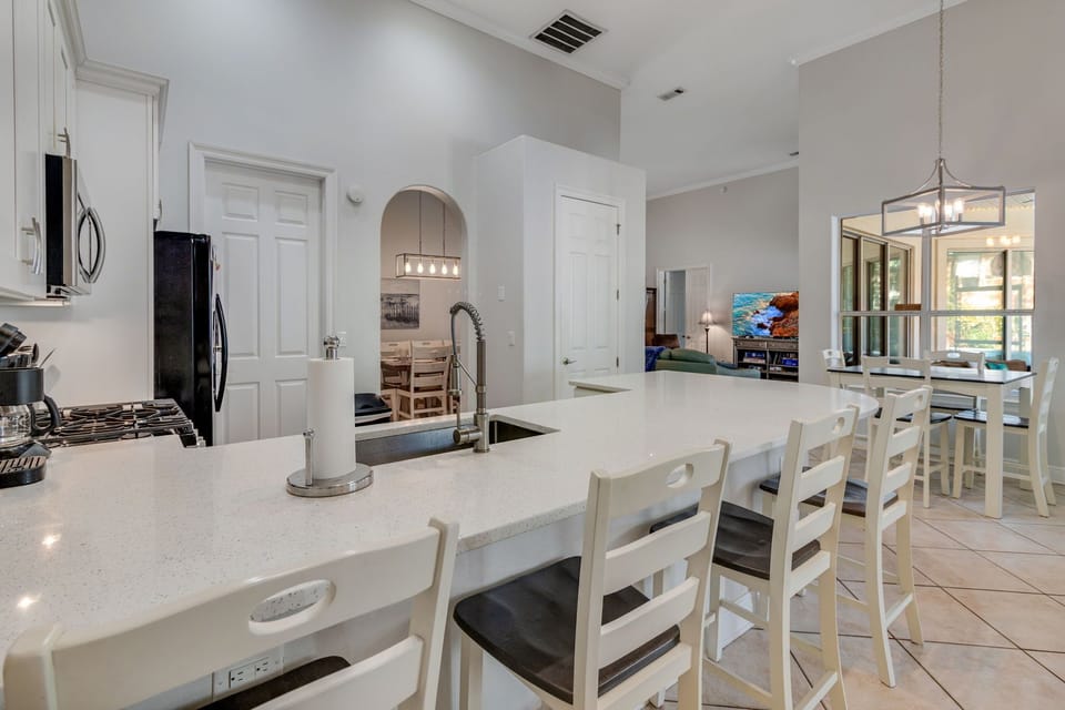 Kitchen has eat-in table, breakfast bar with the sparkle of quartz counters.