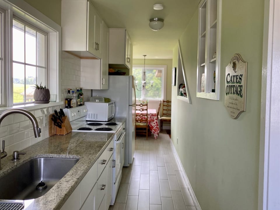 Updated farmhouse galley kitchen fully equipped for all your cooking needs.