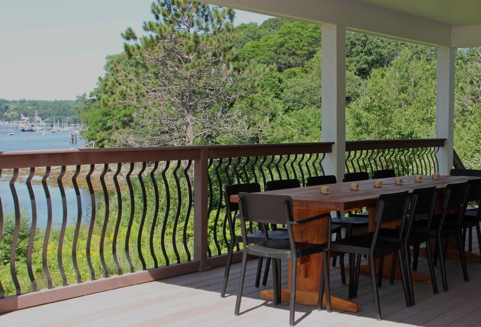 This outdoor deck seats 12 for a meal or cocktails over the ocean. 