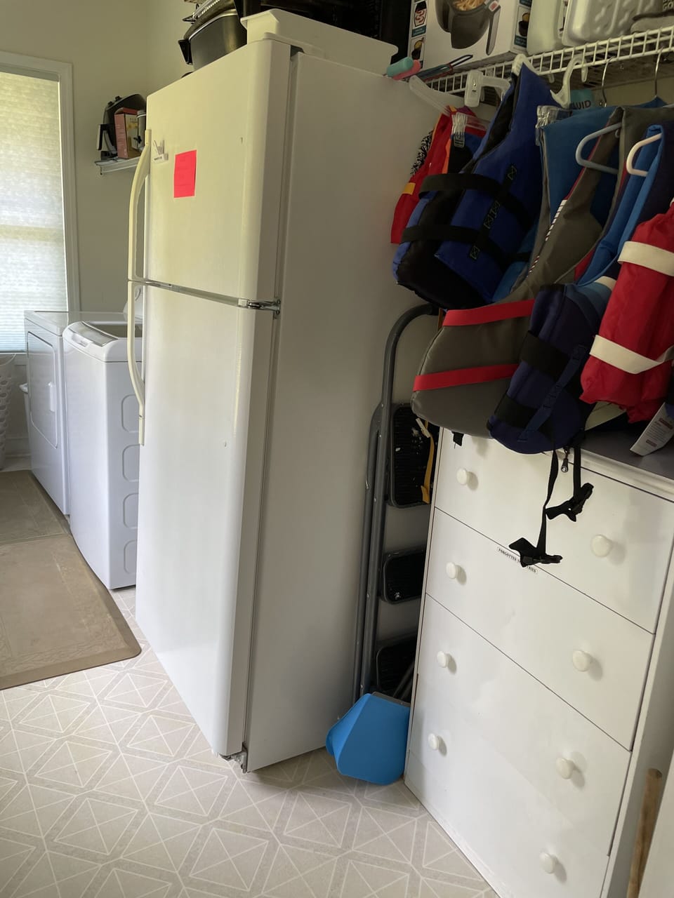 Laundry room with 2nd fridge and life vests of all sizes