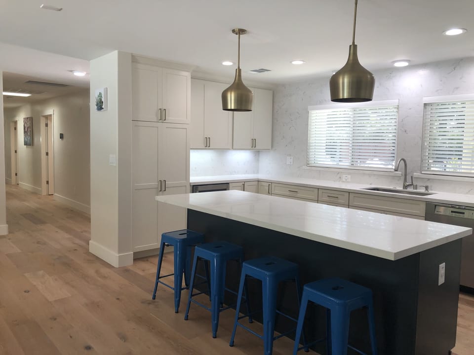 The stylish kitchen is light and bright, with gorgeous quartz countertops.