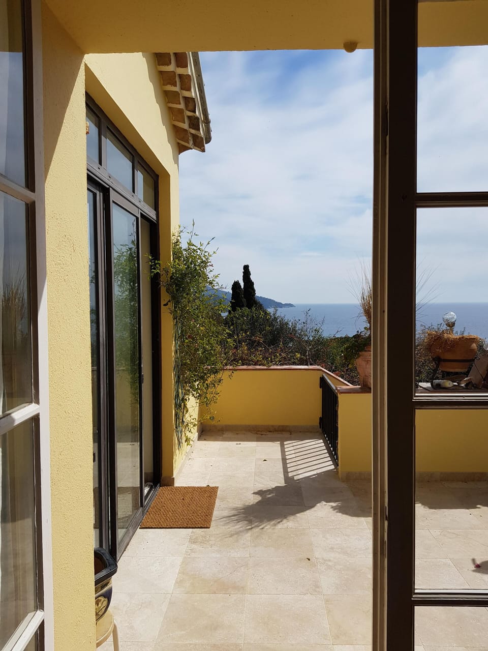 french doors open onto front upper patio from living room