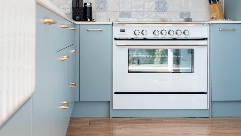 Kitchen with Oven and Blue Cabinets