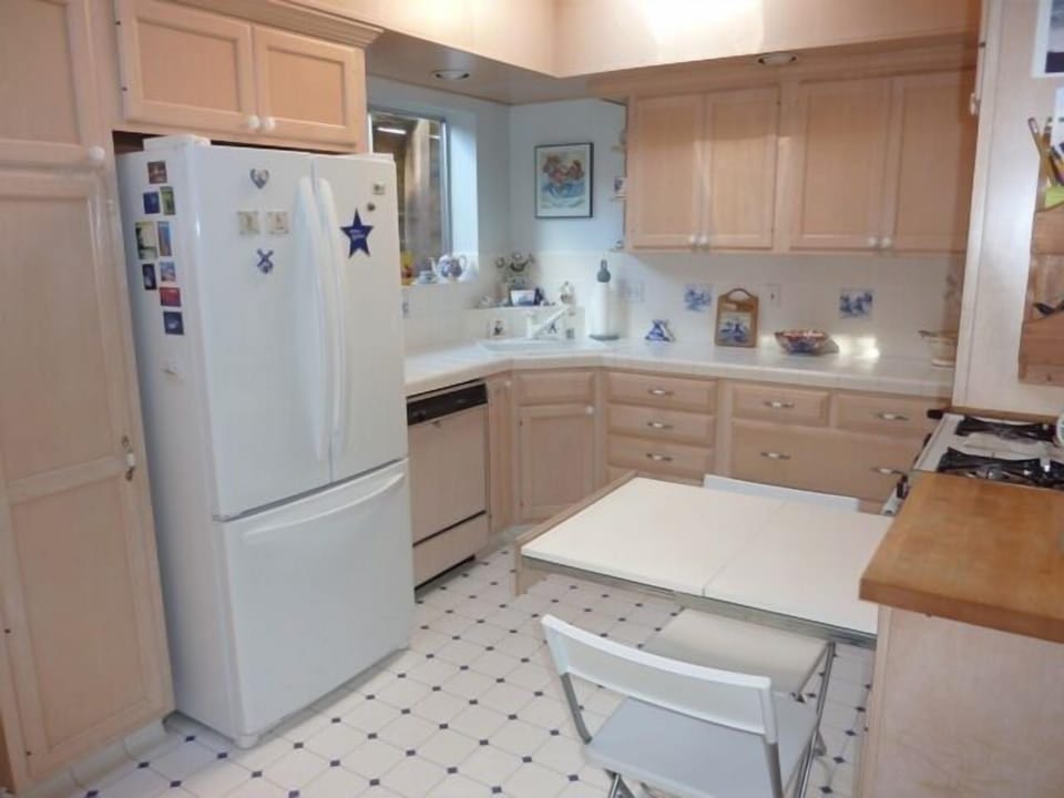 Kitchen with pullout work surface that can be used as a small table