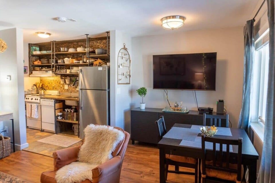 The intimate condo has an open layout space with the living room and dining area connected to the kitchen.