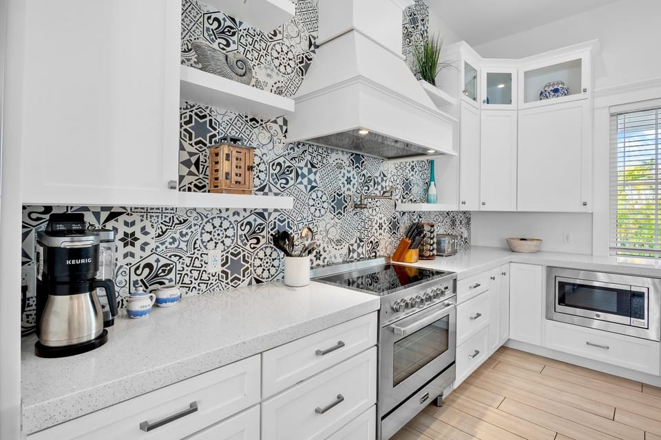 Your fully equipped kitchen features stylish patterned tiles and modern appliances, perfect for preparing meals during your stay.