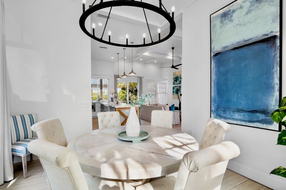Gather around this elegant dining table where natural light streams through, creating the perfect setting for memorable meals and conversations.