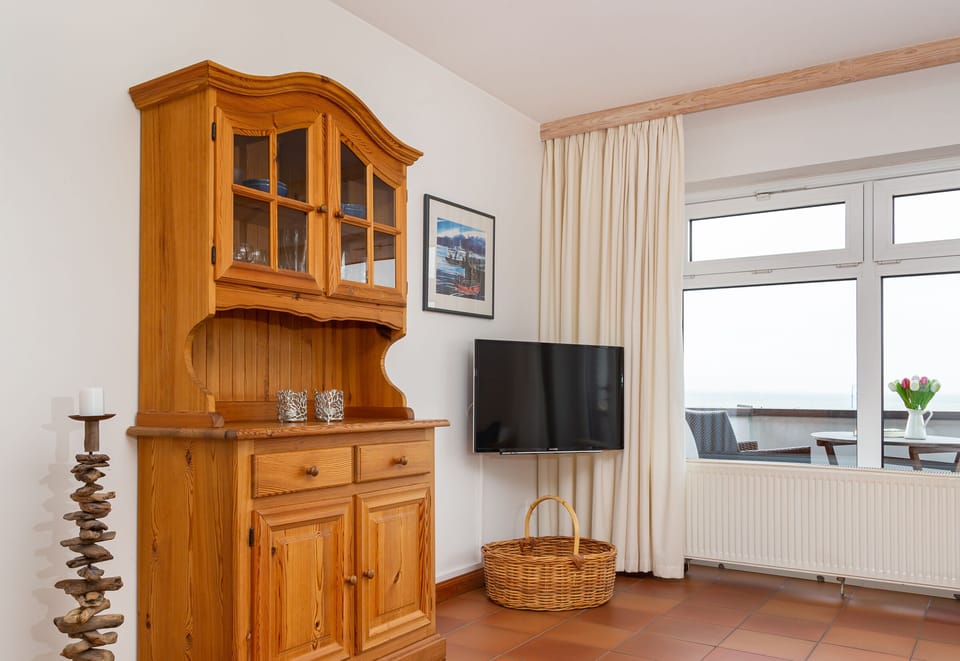 Living room with tv in the holiday apartment Jungnamen Sand 01