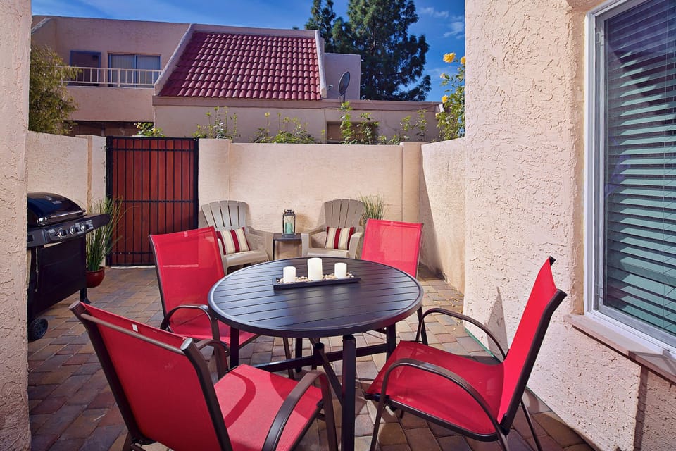 Large private patio with seating area and barbecue.