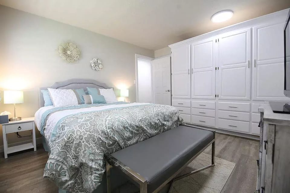 Bedroom with queen bed and large storage.