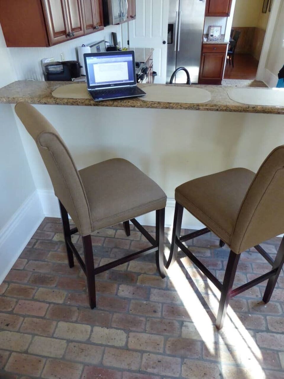 Counter bar in sun-lit kitchen is great for conversation or work station