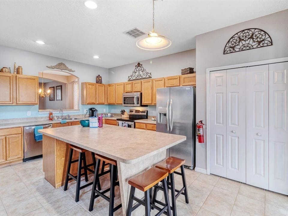 Spacious kitchen with 6 barstools around the island & equipped for all the meals