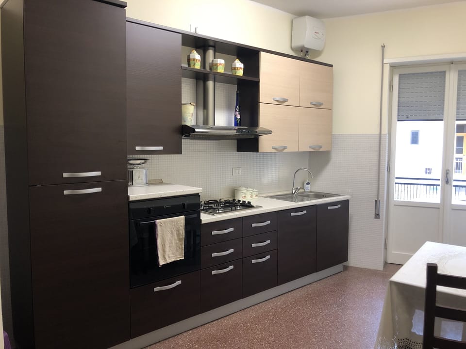 Kitchen with dishwasher, gas hob, electric cooker and fridge freezer.