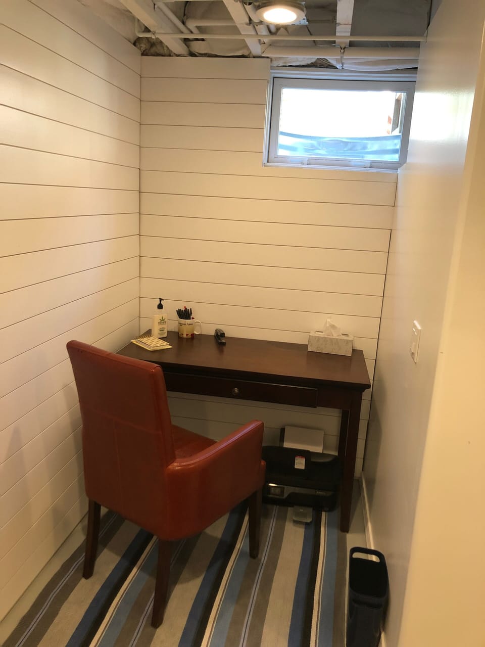 a basement office with natural light and printer