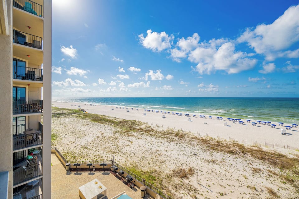 Enjoy the refreshing coastal breeze from your balcony while taking in views of the beach and vibrant blue skies