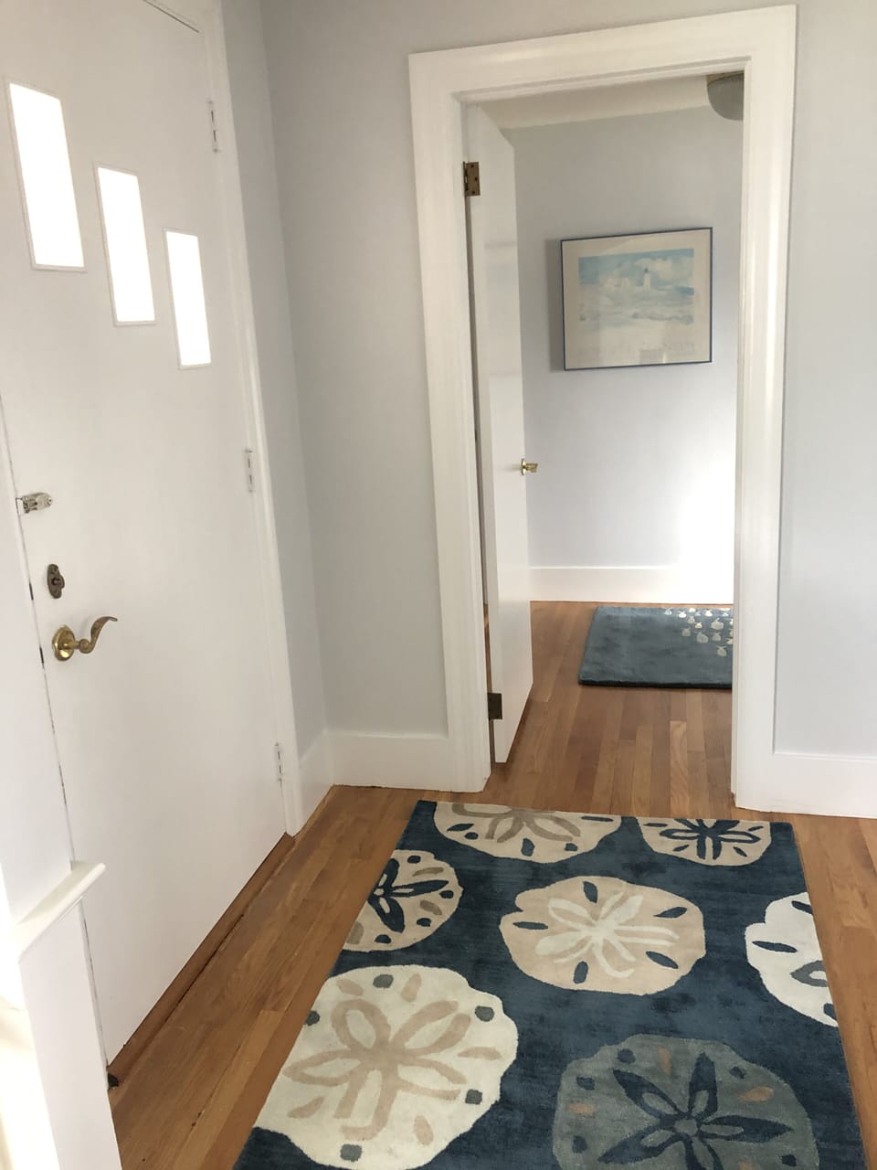 Front door & hall leading to main bath, trundle twin, spiral stairs to 2nd floor
