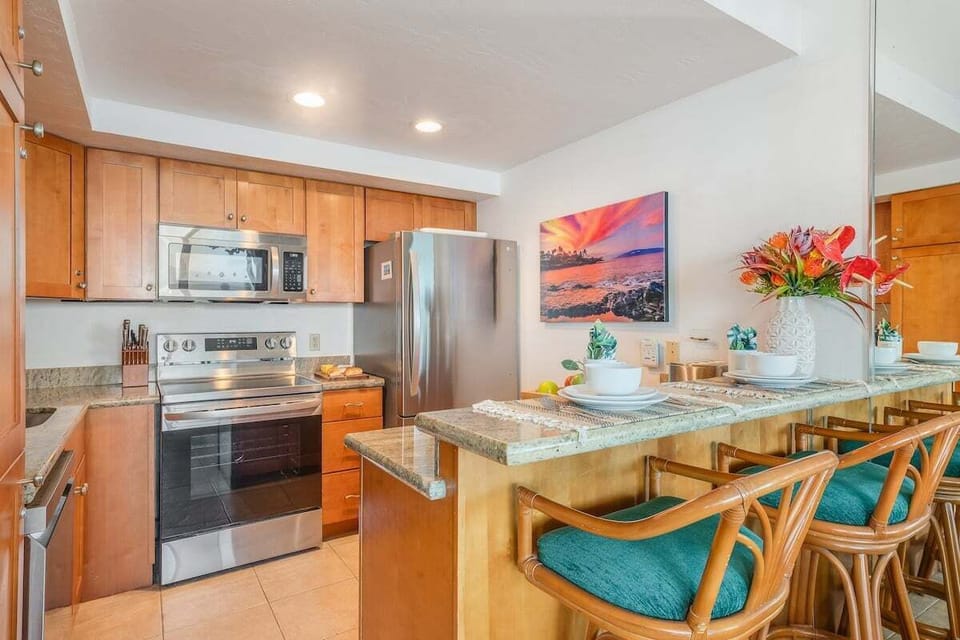 A beautifully updated kitchen with stainless steel appliances and a generous breakfast bar for relaxed island dining