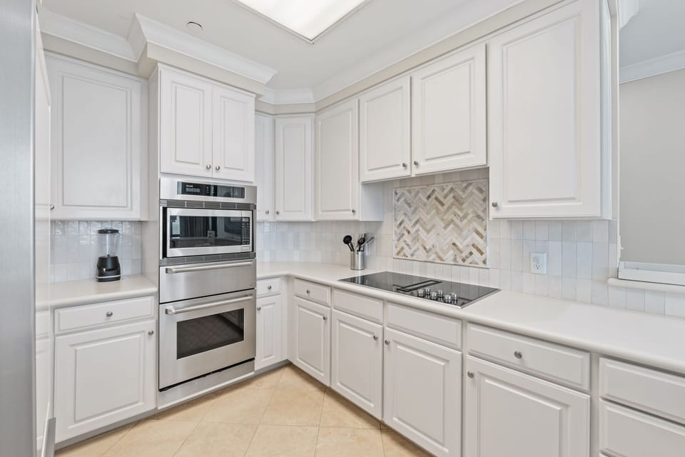 Updated kitchen features plenty of quartz counters and cabinet space.
