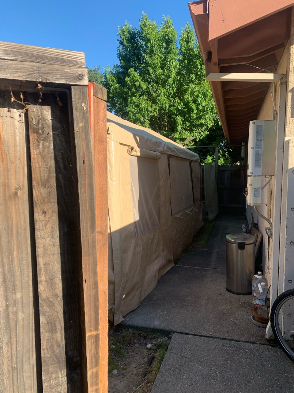 Proceed on the side of the house  and push open the second fence gate,