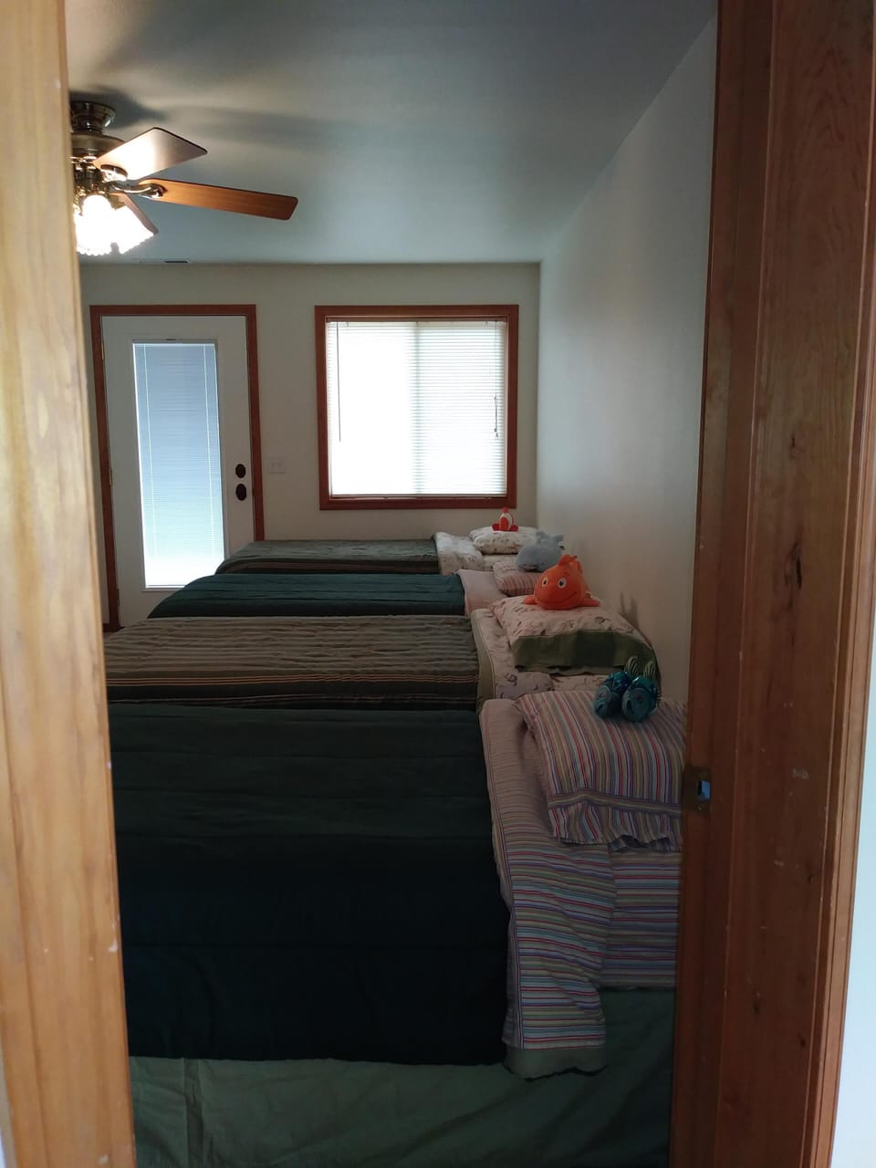 Four single beds, next to lakeview queen bedroom & pool table and ping pong room